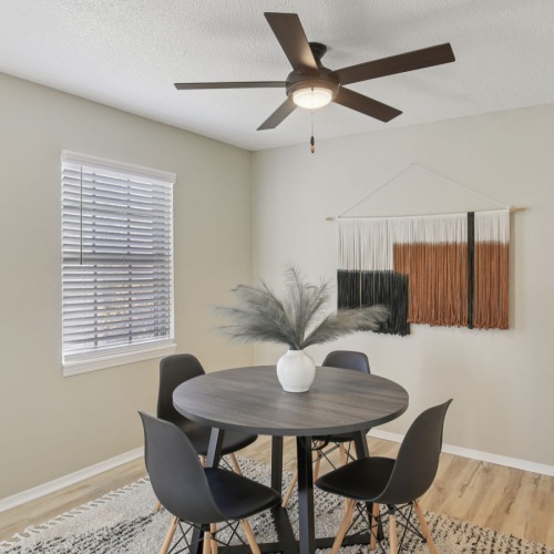 a dining room with a table and chairs
