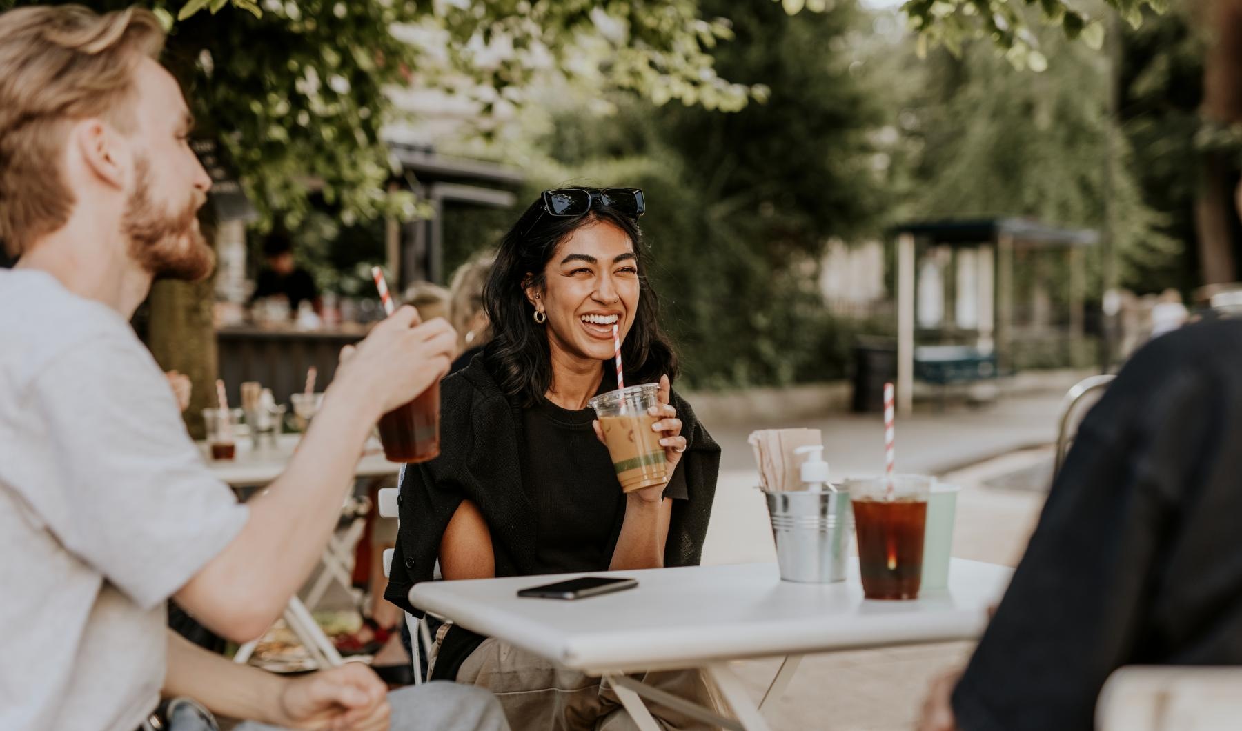 a group of people sitting at a table outside