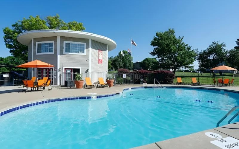 a swimming pool with a building in the background